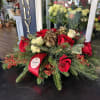 Centerpiece red and white with seasonal decoration and fresh Christmas greens