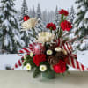 Send whimsical Christmas cheer with this arrangement bursting with charm, playful ribbons