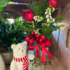 A festive Christmas bud vase with 2 red roses, Christmas greens and