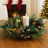 An elegant christmas wreath centrepiece with magnolia, gold accents, and a glowing