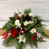 Round Christmas made with pine, seasonal flowers, pinecones, berries, and ribbons.
More flowers