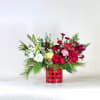 A festive Christmas arrangement bursting with classic holiday colors, rich reds, crisp