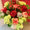 Roses, X-mas greens, hydrangeas and peppermint carnations make up this cute design.