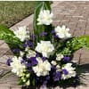 A Mixture of White and Purple blooms to express elegant sympathy