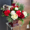 Mix of red and white flowers with pinecones and Christmas greens