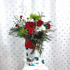 Send this festive holiday stocking full of holiday greens, red roses, green