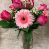 This lovely arrangement of 6 pink roses and 3 complementary pink colored