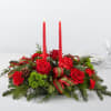 Festive winter greens with tall candles and red and green theme.