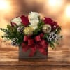 Our Holiday Elegance Centerpiece features a beautiful blend of fresh red and
