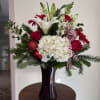 Variety of red and white blooms including roses, gerbera daisies, hydranges and