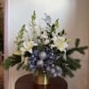 A variety of blooms including lilies, tulips, snapdragons and winter greens. Ornaments