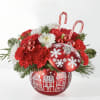 An ornament full of red roses and carnations. Perfect for the holiday