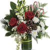 Red roses, creme roses and white snapdragons are wrapped in a variegated