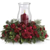  This beautiful Christmas centerpiece with its classic glass hurricane and red