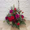 Our white wicker basket holds a gathering of red spray roses, burgundy