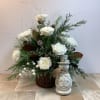 This charming winter arrangement features elegant white roses and spider mums surrounded