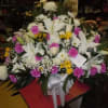 A mixture of white and yellow daisies, ferida carnations, white roses, white