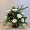 This elegant winter-inspired arrangement features pristine white roses and spider mums, artfully