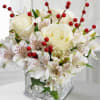 Rudolph the Reindeer features white alstroemeria, crisp white roses, and red berry