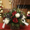 Birchwood cube with Christmas greens, red and white roses, pinecones, red balls