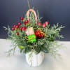 Holiday greens and decor in a 3/3 inch white mug. 