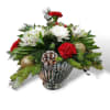 &ldquo;A charming round arrangement in a shiny silver vase, featuring festive greenery
