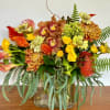 The stunning flower arrangement is made in a unique rectangular vase with