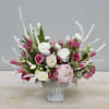 Pink and white florals accented with snowy branches make up this fresh