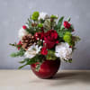A sweet mix of fresh seasonal flowers, greenery, and pine cones in