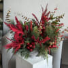 A long-lasting Christmas arrangement crafted with premium seasonal greens and festive accents.