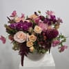 This luxury mixed-berry floral arrangement features an elegant blend of peach roses