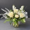 A beautiful winter time arrangement, designed using all white florals, roses, peonies