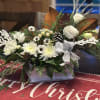 Pure white flowers in this rustic wood sleigh. All white seasonal flowers