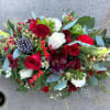 A beautiful low and wide holiday centerpiece of classic colors and style
