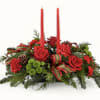 A festive seasonal centerpiece designed with a mix of fresh flowers, winter