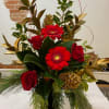 A large vase arrangement showcasing the assorted foliages of magnolia, holly, cedar