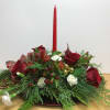 This lovely holiday centerpiece includes roses, mini carnations, hypericum berries and seasonal