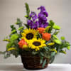 Cheerful basket of bright colors including Roses, Stock &amp; Sunflowers.
