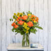 Fresh and vibrant, an assortment of orange, peach and golden blooms in