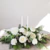Holiday Centerpiece with wintergreens and crisp white florals

includes two 15&quot; taper candles