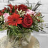 A perfectly cute bouquet of gerberas and roses mixed with a variety