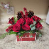 A cozy, festive burst of holiday cheer&mdash;bright red roses, winter berries, pinecones