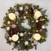 A sophisticated holiday table centerpiece crafted with evergreen foliage, pinecones, and silver