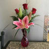 Roses &amp; stargazer lily arranged in glass vase w/ silver heart charm