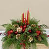 Mix Christmas greens with pinecones, Christmas ball and berries, in a round