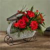 Enjoy this metal sleigh , the prancer bouquet. Fresh christmas greens accented