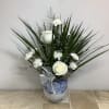 This arrangement features a dramatic, live marginata plant placed in a beautiful