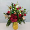 Christmas mix with red roses  in a gold ceramic vase 