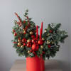 Fresh flower arrangement featuring pine and seasonal ornaments. Some items may be