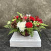 Carnations, chrysanthemums, alstroemeria, snapdragons, berries, in a bed of cedar, decorated with